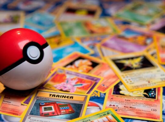 A Poké ball on top of a pile of Pokémon cards.